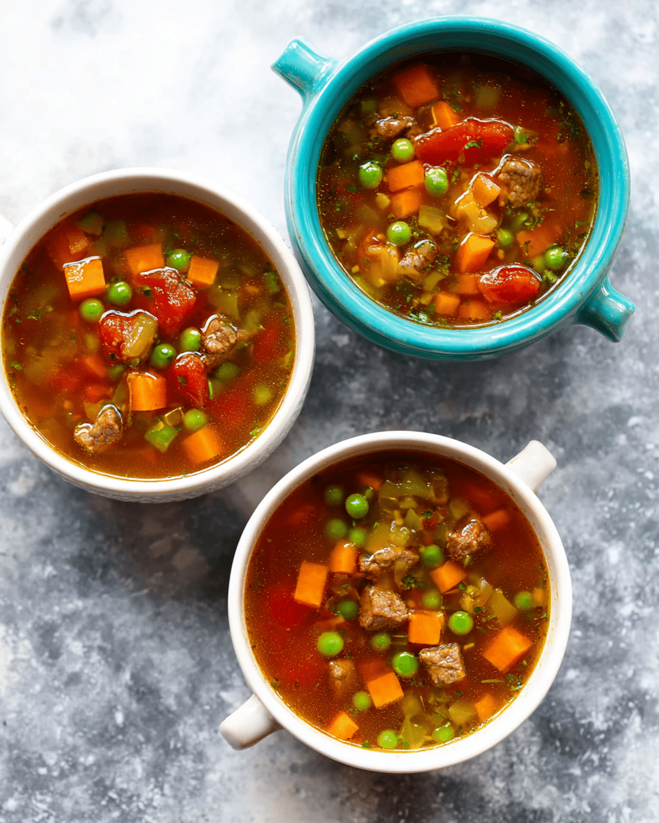 Three bowls of vegetable soup are shown from above, placed on a white marbled surface. Each bowl contains a clear brown broth with visible layers of small diced orange carrots, green peas, light green celery, red tomatoes, and chunks of brown meat. Two of the bowls are white with small handles on each side, while the third bowl is turquoise and round without handles. The vegetables and meat are evenly floating throughout the broth in each bowl. photo taken with an iphone --ar 4:5 --v 7