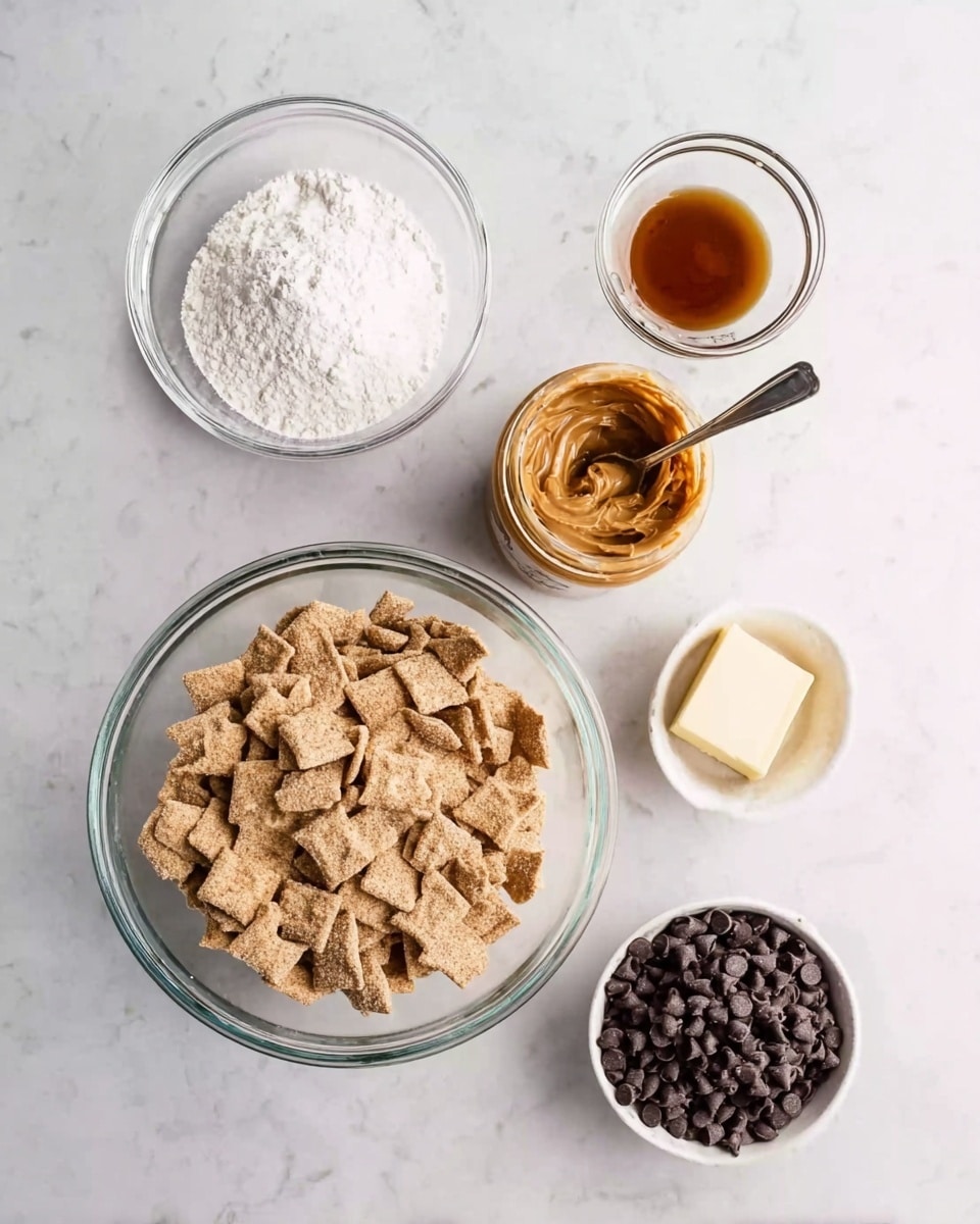 A white marbled surface holds six clear glass bowls and a white measuring cup spread out evenly. The largest bowl at the bottom center is filled with light brown square cereal pieces with visible sugar coating. To the left above it is a medium bowl full of white powdered sugar. Above that is a small glass bowl with a small amount of light brown vanilla extract. To the right of the vanilla is an open jar of peanut butter with a metal spoon inside, showing smooth light brown peanut butter. Below the peanut butter jar is a small rectangular piece of pale yellow butter. On the far right, a white measuring cup sits filled with dark brown chocolate chips. photo taken with an iphone --ar 4:5 --v 7
