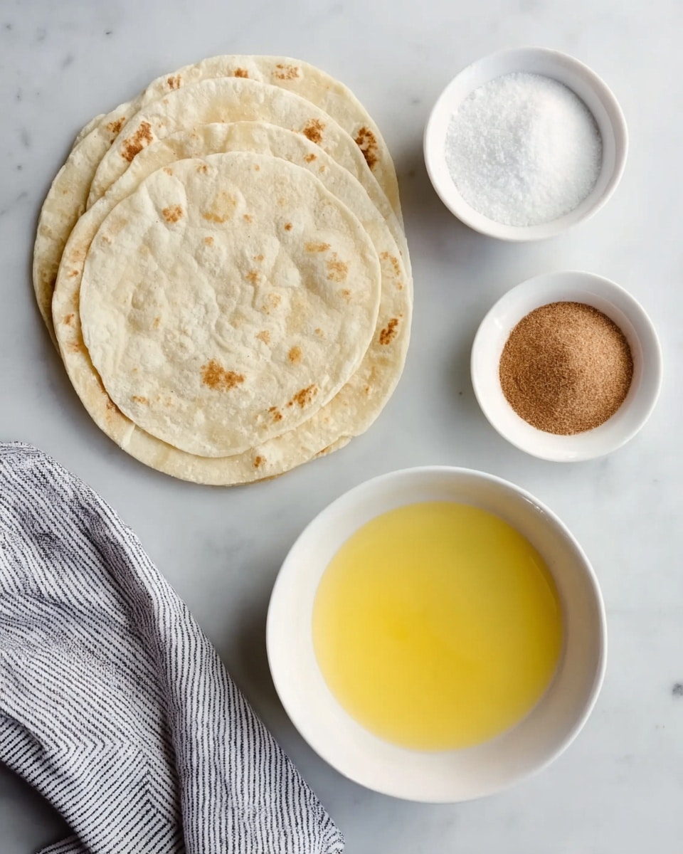 The image shows three round, white tortillas stacked on each other at the top left on a white marbled surface. Below them, to the left, there is a white bowl filled with white granulated sugar, and to the right, a larger white bowl containing melted butter with a smooth, glossy texture. Below these bowls, slightly to the right, there is a smaller white bowl holding a fine light brown powder, likely cinnamon. A striped gray and white cloth is partially visible at the bottom left corner. photo taken with an iphone --ar 4:5 --v 7