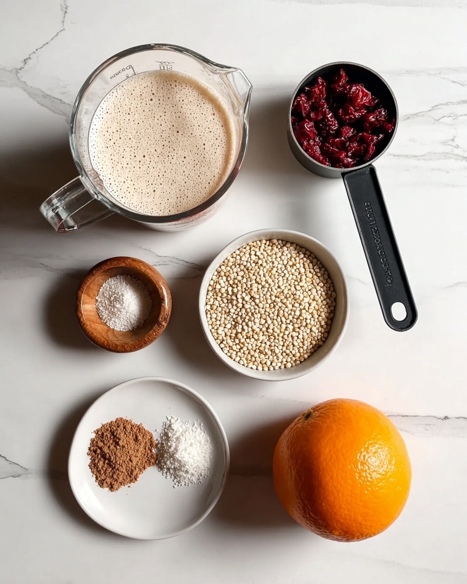 The image shows six ingredients on a white marbled surface. At the top left, there is a clear glass measuring cup filled with a frothy light beige liquid. To the right of the cup, there is a black measuring cup filled with small, round white grains. Below the measuring cup, to the left, is a small wooden bowl with fine white granules. At the bottom left, a white plate holds two small piles of brown powders side by side. To the right of the plate, there is a whole orange with a bright, smooth skin. Next to the orange on the right, there is a small pile of dried red berries. Photo taken with an iphone --ar 4:5 --v 7