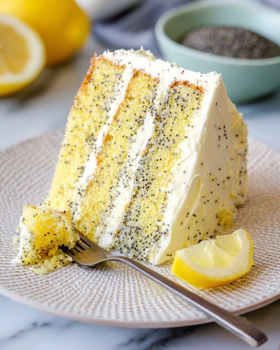 A slice of three-layer yellow cake speckled with small dark poppy seeds is shown on a white plate with a textured pattern. Each layer of the cake is separated by smooth white frosting that also covers the outside edges, creating a soft contrast with the yellow cake. A small piece of cake is on a fork resting on the plate, showing the same speckled texture. A small lemon wedge is placed on the plate near the cake slice. The background includes a blurred lemon half and a bowl with more poppy seeds on a white marbled surface. Photo taken with an iphone --ar 4:5 --v 7
