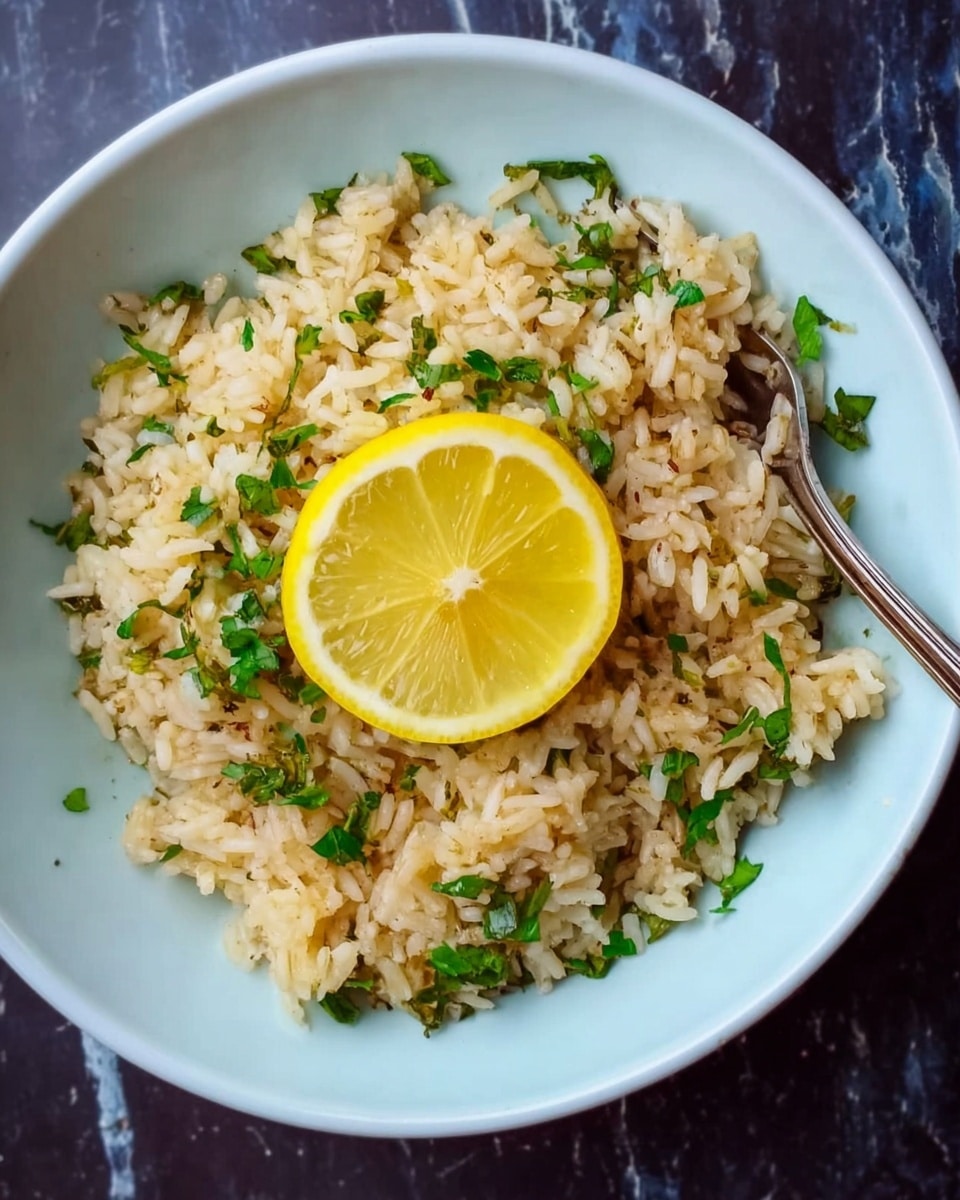 A deep white bowl filled with light brown rice mixed with chopped green herbs spread evenly throughout. On top of the rice lies a bright, fresh yellow lemon slice placed slightly off-center. A silver fork rests on the right edge of the bowl. The bowl is placed on a white marbled surface. photo taken with an iphone --ar 4:5 --v 7