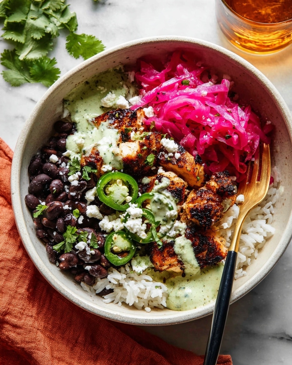 A white bowl filled with layers starting with white rice at the bottom, followed by dark black beans on one side. On top are pieces of grilled, browned fish with a light green creamy sauce drizzled over them. Bright pink pickled cabbage is placed next to the fish, decorated with slices of green jalapeño and sprinkled with small white cheese crumbles. Fresh green cilantro leaves are scattered on top for garnish. A gold and black spoon is inside the bowl. The bowl sits on a white marbled surface with a glass of amber liquid nearby and a folded orange cloth close by. photo taken with an iphone --ar 4:5 --v 7