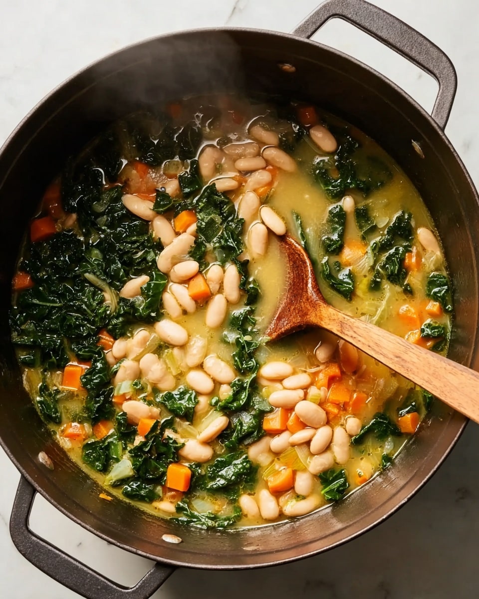 A round black pot filled with a soup that has three main layers: light beige white beans on one side, dark green leafy kale spread throughout, and small orange carrot cubes mixed in, all floating in a pale yellow broth. A wooden spoon with a rounded tip is partially submerged in the soup, resting near the center. The pot is placed on a white marbled surface, and light steam rises gently from the hot soup. Photo taken with an iphone --ar 4:5 --v 7