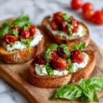 Pesto Ricotta Crostini with Roasted Cherry Tomatoes Recipe