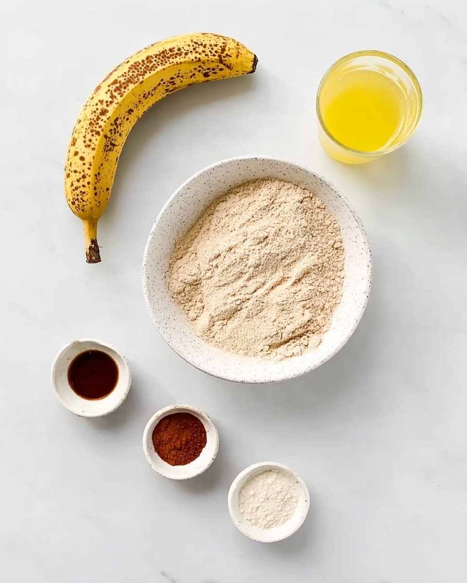 A white speckled bowl filled with a light brown flour mix sits near the center on a white marbled surface, with a ripe banana showing brown spots placed to the upper left of the bowl. To the upper right, there is a clear glass filled with yellow liquid. Below, from left to right, are three small white bowls containing a dark brown liquid, a reddish brown powder, and a translucent white powder, spaced evenly in a row. The overall setting is clean and bright, with all items neatly arranged. Photo taken with an iphone --ar 4:5 --v 7