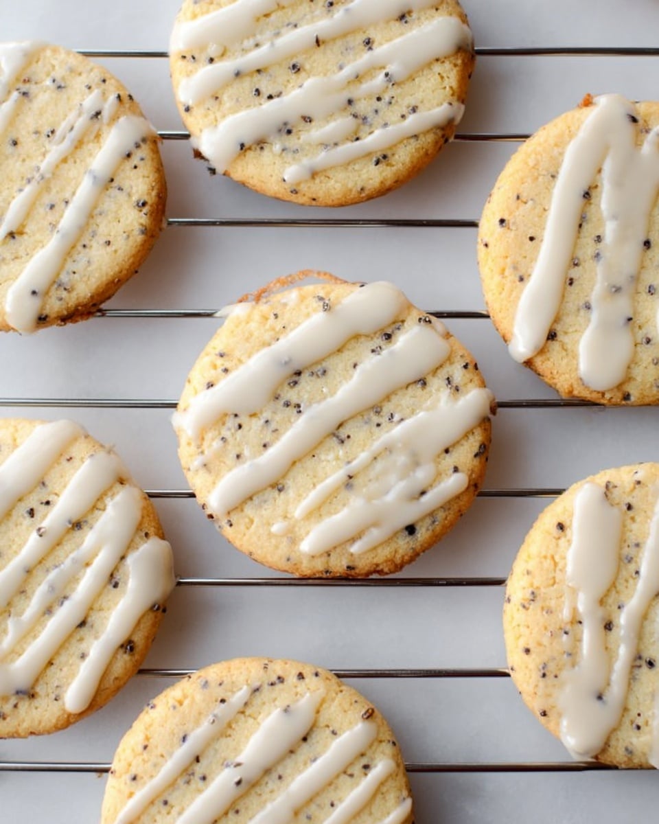 The image shows round cookies with a light golden color and small dark specks throughout, placed on a metal cooling rack over a white marbled surface. Each cookie has a thin layer of white icing drizzled randomly on top in irregular patterns. The cookies have a slightly rough texture, and the metal rack has evenly spaced thin bars creating a simple grid below them. Photo taken with an iphone --ar 4:5 --v 7