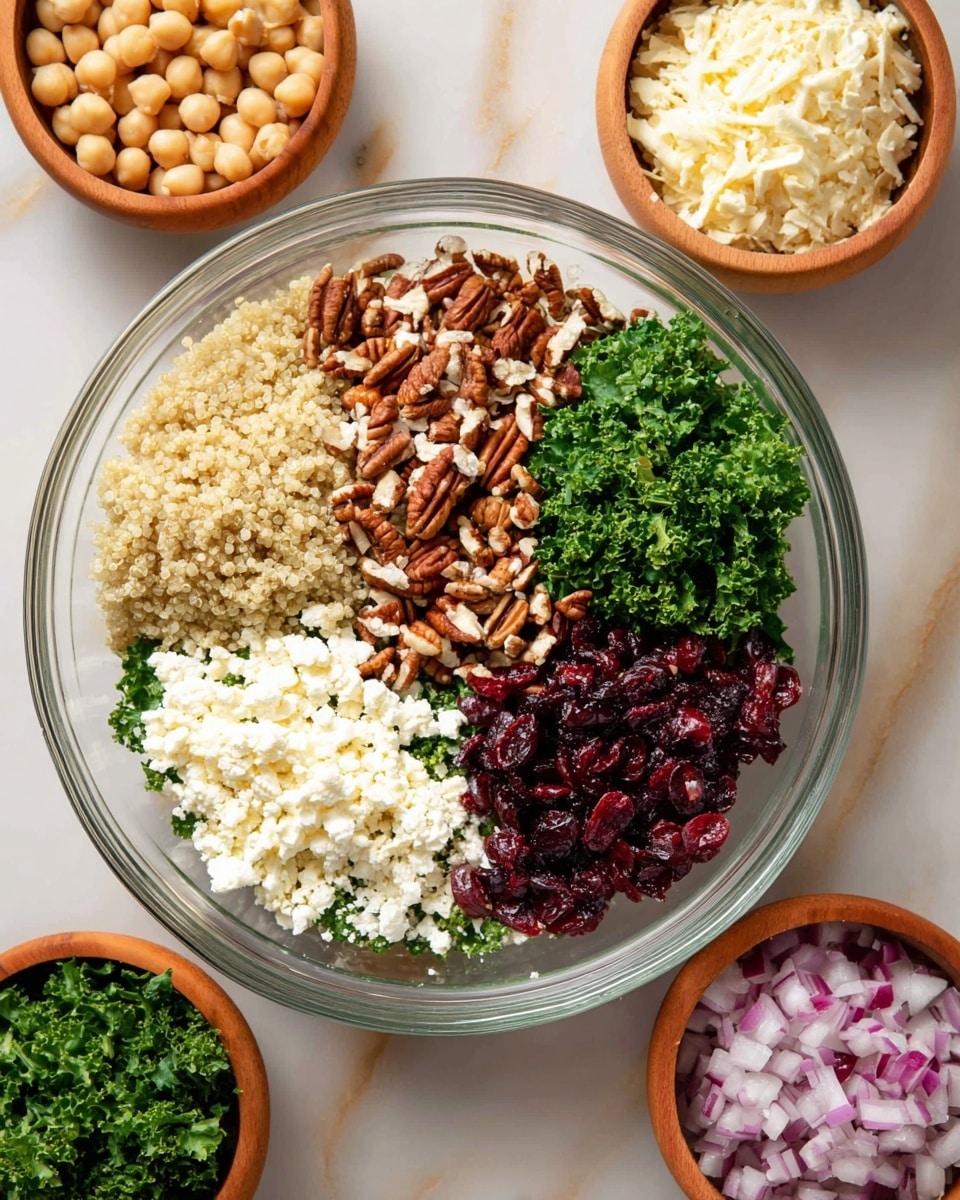 A clear glass bowl filled with seven distinct layers arranged in sections: light beige quinoa on the top left, chopped pecans with brown and cream colors in the center top, bright green curly kale on the top right, white crumbled cheese on the middle right, dark red dried cranberries on the bottom right, round pale yellow chickpeas on the bottom left, and finely chopped purple-red onions on the middle left. Surrounding the main bowl are smaller bowls on a white marbled surface, containing additional chopped kale, quinoa, dried cranberries, pecans, crumbled cheese, and chopped onions. photo taken with an iphone --ar 4:5 --v 7