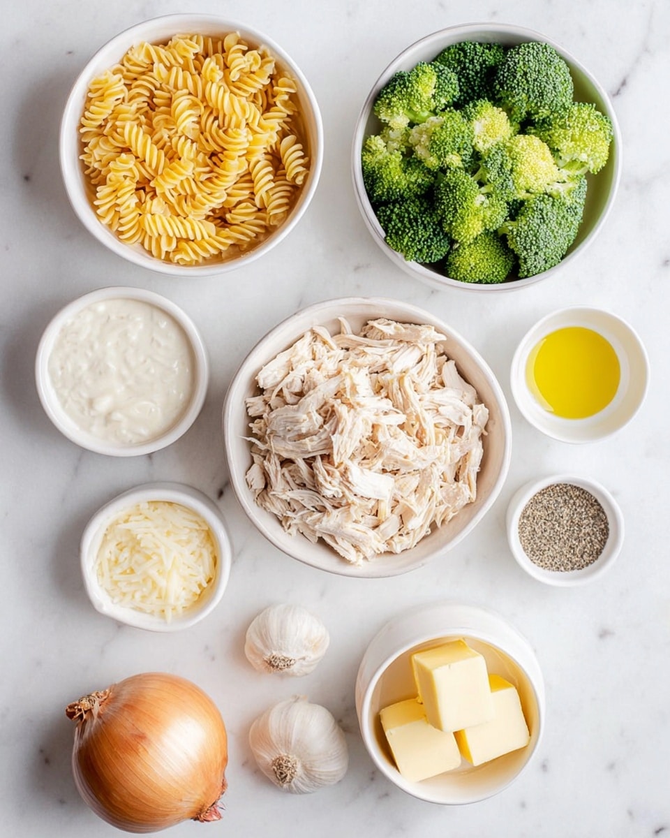 Top view of several white bowls and a white plate on a white marbled surface. The largest bowl in the center holds shredded light beige chicken. To its top left, a medium bowl is filled with dry, yellow spiral pasta. Below that, a smaller bowl contains frozen bright green broccoli florets. To the right of the chicken bowl, a small bowl has creamy white sauce, another small bowl with shredded pale yellow cheese, and a tiny bowl with yellow oil. Further down, a small bowl contains pale yellow butter cubes. Near the bottom right, a tiny bowl holds black and white pepper. At the bottom left corner, a whole light brown onion sits next to two peeled cloves of garlic. Photo taken with an iphone --ar 4:5 --v 7