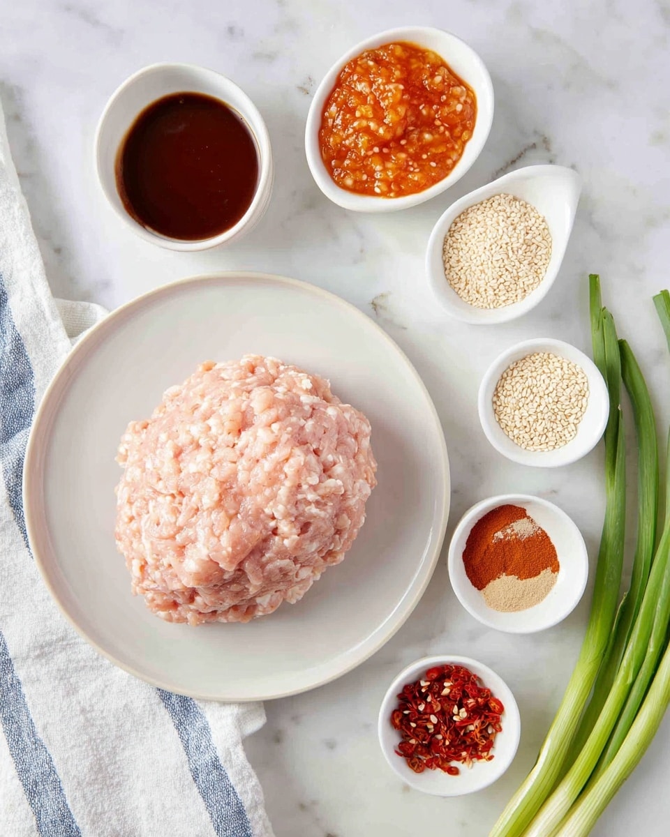 A white plate with a large mound of pale pink ground chicken in the center is placed on a white marbled surface. Surrounding the plate are five small white bowls, each containing different ingredients: thick dark brown sauce in the top left bowl, chunky orange sauce with visible minced bits in the top middle bowl, off-white sesame seeds in the middle right bowl, light brown powder in the bottom middle bowl, and red chili flakes in the bottom right bowl. Three fresh green onions with white ends are placed diagonally on the right side. A white cloth with blue stripes is visible on the left edge. Photo taken with an iphone --ar 4:5 --v 7