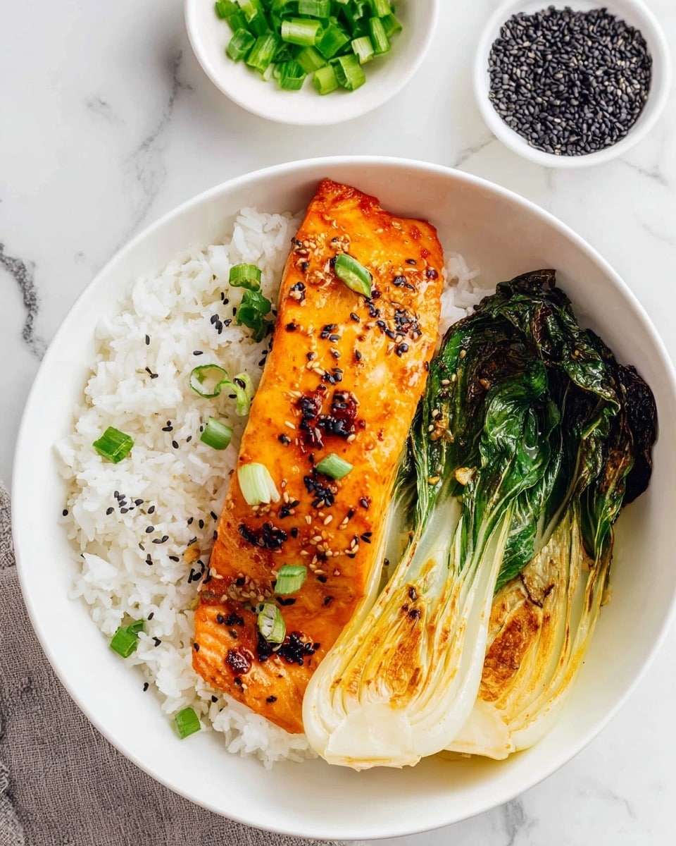A white bowl with three layers: the bottom layer is plain white rice, fluffy and soft; on the left side, a grilled salmon fillet with a shiny orange glaze, topped with black sesame seeds and small green onion pieces; on the right side, two green baby bok choy, cooked and slightly browned on the edges. The bowl is set on a white marbled surface, with a small white bowl of black sesame seeds and a small white bowl of chopped green onions in the background. photo taken with an iphone --ar 4:5 --v 7