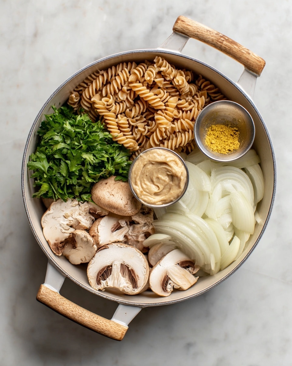 A white pot with wooden handles is placed on a white marbled surface. Inside the pot, dry spiral pasta occupies the upper left section, light brown in color with a twisted texture. Below the pasta, there is a bunch of fresh green parsley with smooth leaves. The lower half holds a cluster of sliced mushrooms, showing light brown caps with white inner parts and stems. To the right of the mushrooms is a pile of thinly sliced white onion, laid in overlapping layers. On top of the onion, two small silver bowls rest: the upper bowl contains yellow powder, and the lower bowl has a beige creamy paste with a swirled texture. Photo taken with an iphone --ar 4:5 --v 7