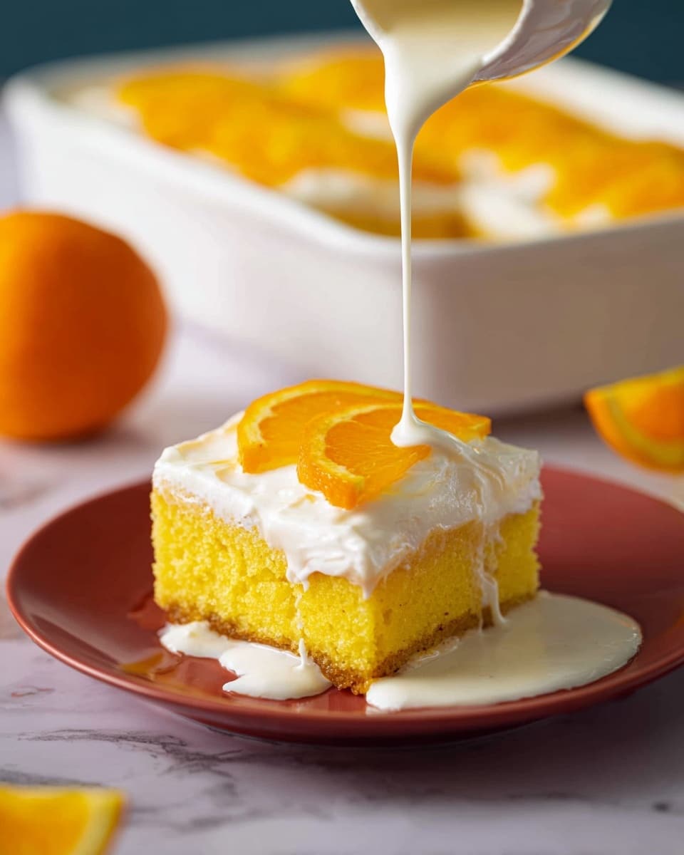 A white plate holds a single square piece of cake with three layers: the bottom layer is moist and bright yellow, the middle layer is a thick white cream, and the top layer has thin, smooth orange slices neatly arranged. A creamy white liquid is being poured over the cake from above, gently flowing down the side and pooling on the plate. In the background, a white dish with more cake topped with orange slices and a whole orange fruit are visible, all set on a white marbled surface. Photo taken with an iphone --ar 4:5 --v 7