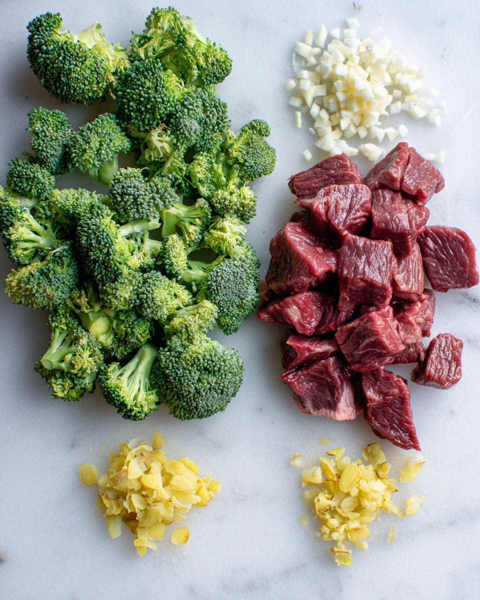 The image shows four groups of fresh ingredients on a white marbled surface. On the left, there is a large pile of bright green broccoli florets with a rough, textured surface. Above the broccoli, there is a small heap of finely chopped white garlic cloves. On the right, there is a pile of reddish-brown, raw beef cubes with a slight shine and soft texture. Below the beef, there is a small pile of finely chopped yellow ginger pieces with a slightly fibrous look. The ingredients are spaced apart evenly, creating a clean and organized layout. Photo taken with an iphone --ar 4:5 --v 7