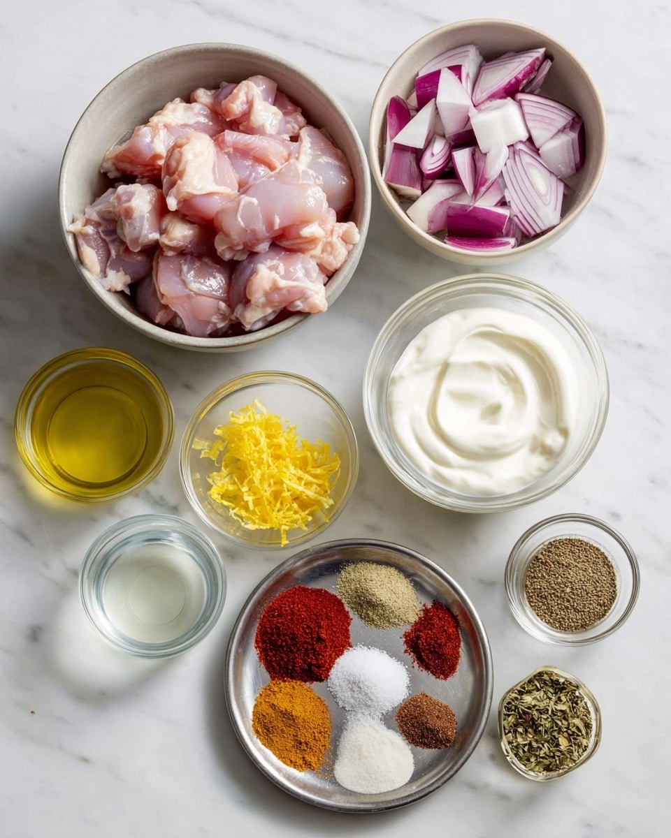 The image shows several bowls with ingredients on a white marbled surface. The largest bowl contains raw pink chicken pieces with slight fatty parts. Next to it, a medium bowl holds cubed purple red onions with white stripes. Another bowl is filled with thick, creamy white yogurt. A small clear bowl holds bright yellow lemon zest, and below it, there is a small amount of light yellow oil in another bowl. A separate small bowl has a clear liquid, likely lemon juice. A metal plate contains nine sections of different spices: bright red paprika, white salt, pale beige garlic powder, dark red sumac, green dried herbs, black pepper, and brown ground spices all arranged in neat piles. Photo taken with an iphone --ar 4:5 --v 7