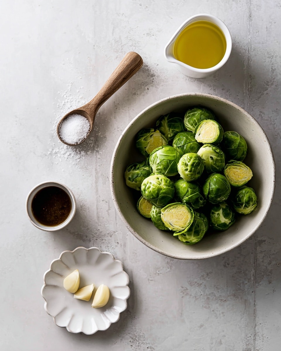 The image shows a white bowl filled with fresh green Brussels sprouts, some whole and some cut in half, placed at the right side on a white marbled surface. Above the bowl, there is a small white cup with a yellow liquid, likely olive oil. To the left of that, there is a white scoop holding coarse salt with a wooden handle. Below the scoop, there is a small white bowl with a dark brown sauce inside. At the bottom center of the image, a small white plate with a scalloped edge holds two peeled garlic cloves. photo taken with an iphone --ar 4:5 --v 7