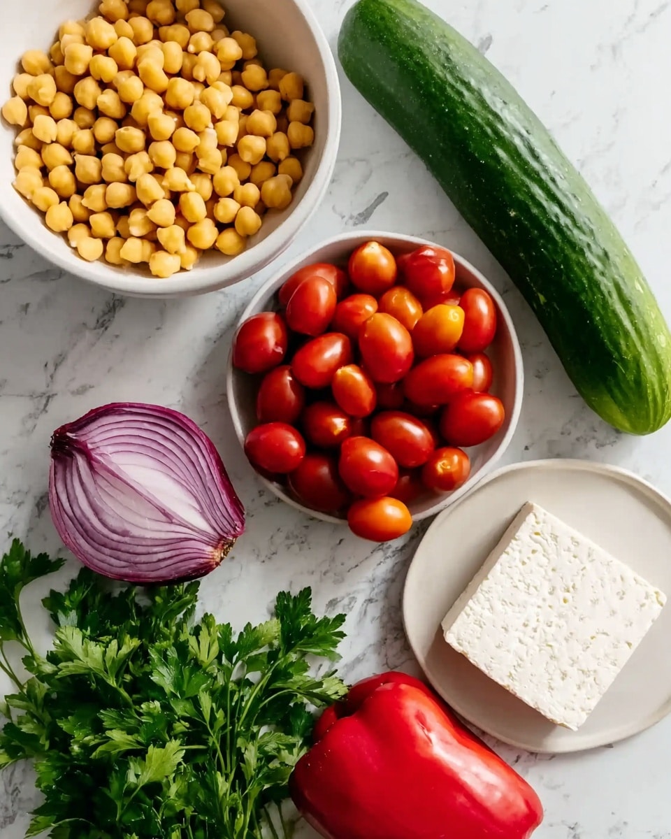 The image shows fresh ingredients arranged on a white marbled surface, including a large white bowl filled with yellow chickpeas at the top left, a large green cucumber placed vertically to the right, a white bowl with many small red grape tomatoes in the center, a half purple onion with visible layers at the left middle, a bright red bell pepper on the right bottom, a white plate with a block of white feta cheese near the center bottom, and fresh green parsley with stems on the lower left. Photo taken with an iphone --ar 4:5 --v 7