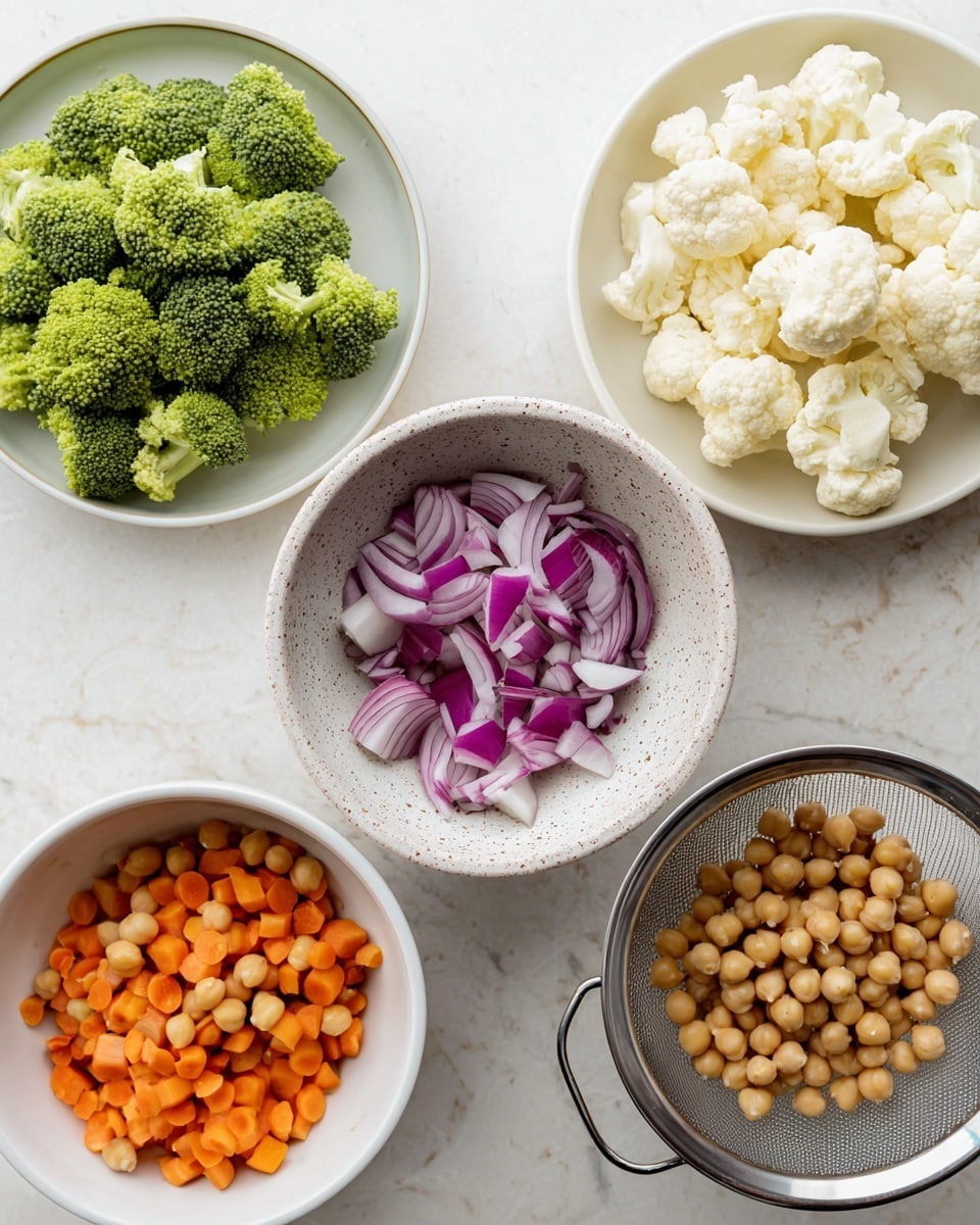 The image shows five containers with different prepared ingredients on a white marbled surface. At the top left, a white plate holds bright green broccoli florets with a textured, bumpy look. At the top right, another white plate contains creamy white cauliflower florets with rough, flower-like shapes. In the center, a speckled white bowl has chopped red onions, showing layers of purple and white. At the bottom left, a white bowl is filled with small, round orange carrot slices, smooth in texture. At the bottom right, a metal strainer holds light brown chickpeas, round and smooth, filling the colander. Photo taken with an iphone --ar 4:5 --v 7