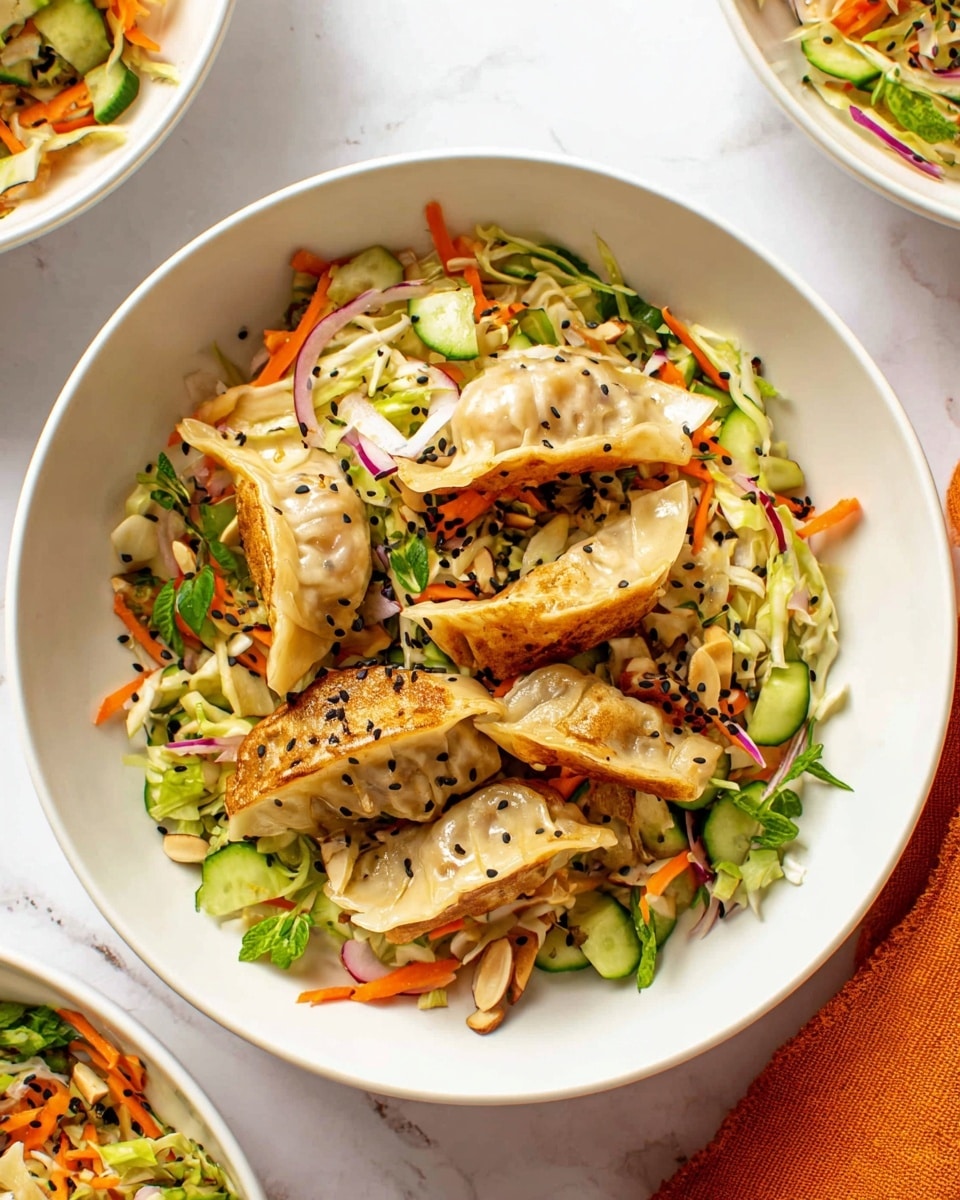 A white bowl filled with a colorful mix of food, layered with golden-brown pan-fried dumplings on top. Beneath the dumplings is a bed of shredded vegetables including light green cabbage, bright orange carrots, and thin slices of red onion. Scattered among the vegetables are fresh, bright green cucumber chunks and small almond slices. Black sesame seeds and fresh green leaves are sprinkled over the whole dish, creating a fresh and vibrant look. The bowl is on a white marbled surface, partially showing another similar white bowl nearby and part of an orange cloth on the side. Photo taken with an iphone --ar 4:5 --v 7