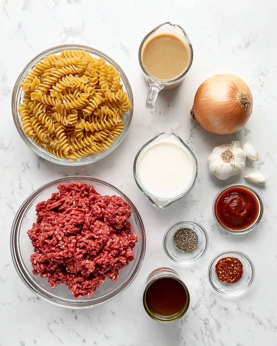 The image shows a top view of cooking ingredients on a white marbled surface. There are two clear glass bowls, one filled with raw ground beef and the other with uncooked spiral pasta, both placed to the left. Above the pasta and beef are two clear measuring cups, one with a white creamy liquid and the other with a light brown broth. To the right, there is a whole onion, two garlic cloves, a small clear bowl with red chili flakes, another small clear bowl with black pepper, a small glass bowl with a dark red sauce, and an open can containing tomato paste. All items are evenly spaced, creating a simple and organized look. Photo taken with an iphone --ar 4:5 --v 7