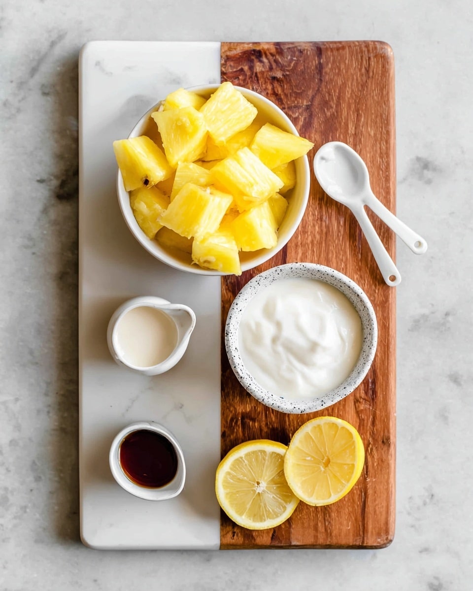 A white bowl filled with bright yellow pineapple chunks sits on the top left of a white marble and brown wood cutting board. To the right of the bowl is a small white spoon with dark brown liquid inside. Below the bowl is a speckled white cup filled with thick white cream, and to its left, a white spouted cup holding a light cream-colored liquid. At the bottom left of the board is a small white dish with a dark brown liquid, and to the right of it are two halves of a bright yellow lemon resting directly on the white marble surface. Photo taken with an iphone --ar 4:5 --v 7