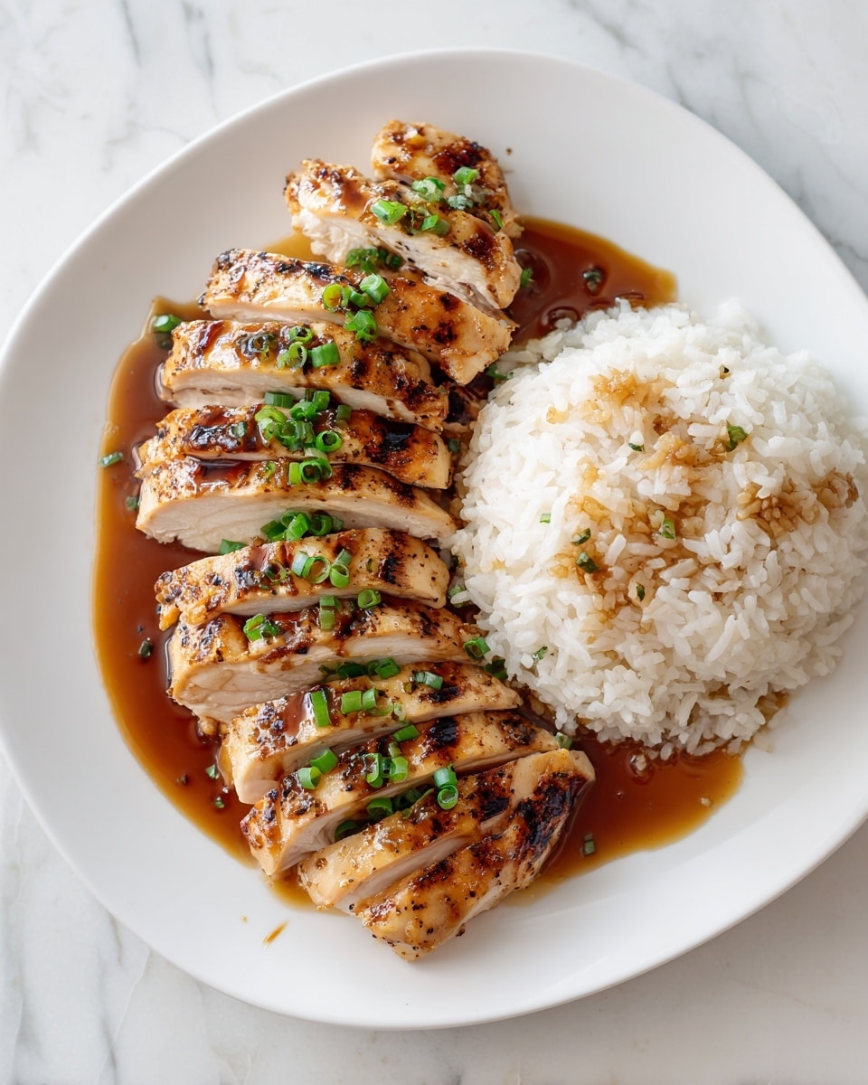 On a white plate, there are five slices of grilled chicken arranged in a neat row on the left side, each slice showing a light golden-brown crust with a shiny brown sauce drizzled on top and small green onion pieces scattered across the chicken. To the right of the chicken, there is a mound of white rice with a few drops of brown sauce mixing into it, giving parts of the rice a light brown color. The plate sits on a white marbled surface. photo taken with an iphone --ar 4:5 --v 7