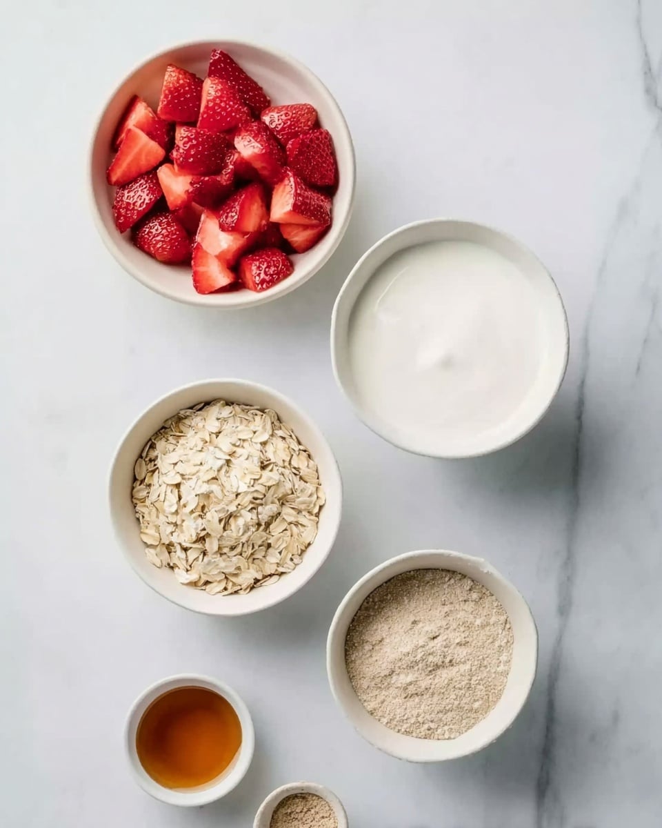 The image shows five white bowls placed on a white marbled surface. The top bowl is filled with bright red chopped strawberries, showing juicy and fresh pieces. To its right, a larger white bowl is filled with smooth, plain white yogurt. Below these, a medium white bowl holds light beige rolled oats with a rough texture. To the left of the oats, a small white bowl contains fine, light brown powder, likely a spice or ground ingredient. At the bottom left, a partially visible small white bowl holds a darker amber liquid, likely honey or syrup. Photo taken with an iphone --ar 4:5 --v 7