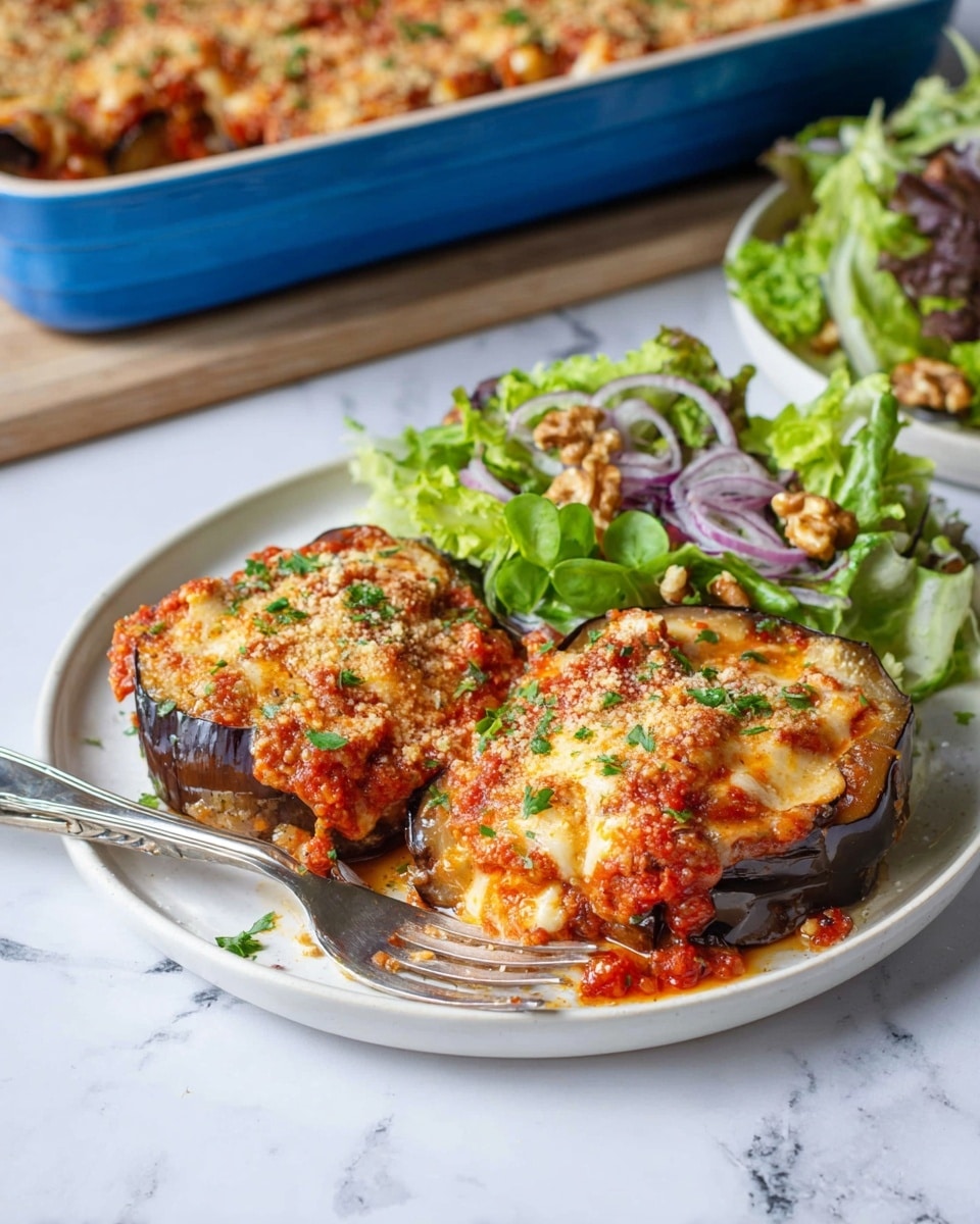 The image shows two thick slices of stuffed eggplant on a white plate, each slice layered with dark purple eggplant skin on the bottom, topped with chunky red tomato sauce mixed with small orange bits, melted golden cheese with a slightly browned texture, and sprinkled with green parsley and light brown breadcrumbs. To the side, there is a fresh green salad with dark and light green leafy lettuce, thin rings of red onion, and small walnut pieces. A silver fork is placed on the plate, partly under the salad. The plate sits on a white marbled surface. In the background, there is a blue rectangular baking dish filled with more of the stuffed eggplant dish. Photo taken with an iphone --ar 4:5 --v 7