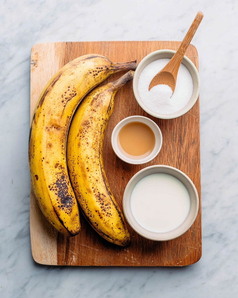 Two large ripe plantains with yellow skin and many brown spots rest on the bottom left of a wooden cutting board. On the top right side of the board, three small white ceramic bowls hold different ingredients: the top bowl contains a light brown liquid, the middle bowl holds white sugar with a wooden spoon resting on top, and the bottom bowl is filled with white cream or milk. The board is placed on a white marbled surface. photo taken with an iphone --ar 4:5 --v 7