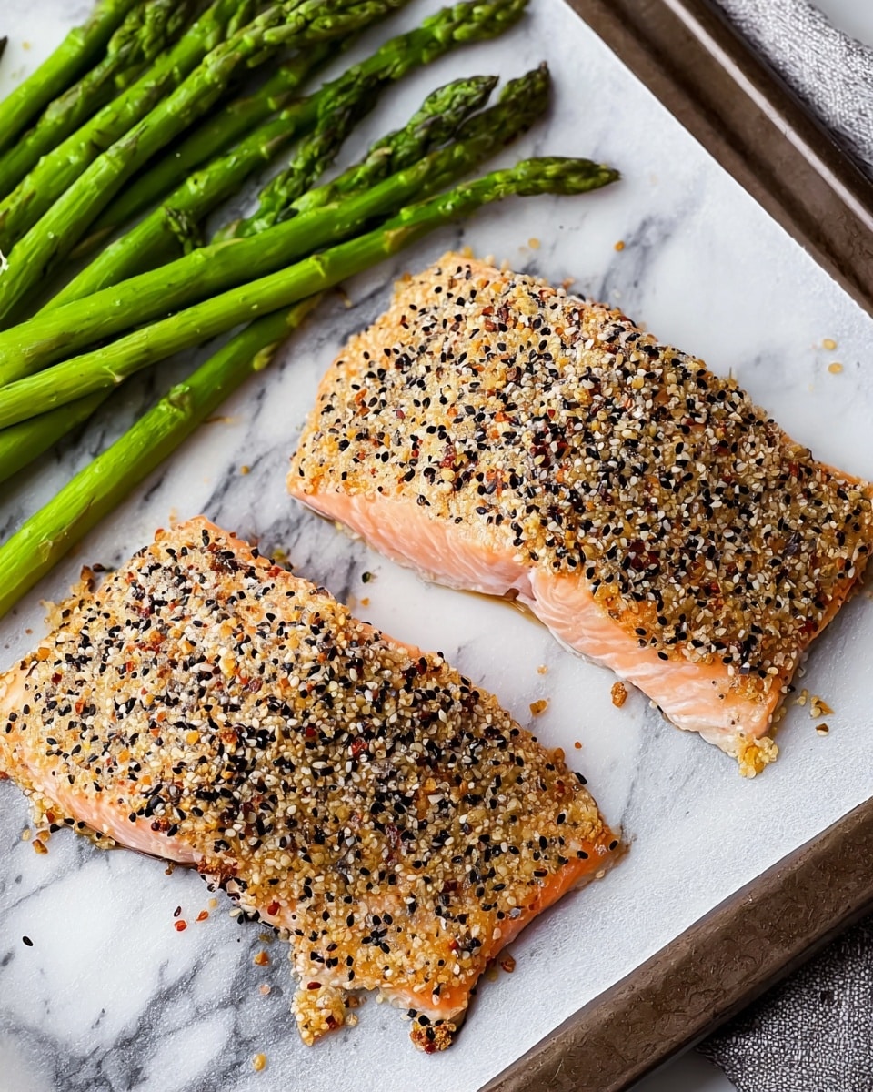 The image shows two pieces of cooked salmon fillets on a white marbled surface, both topped with a thick, even layer of mixed seeds and spices, including sesame seeds in black and white; the salmon has a light pink color with a slightly crispy edge. Above the fillets, on the same surface, there are several bright green cooked asparagus spears placed loosely. The whole setting appears on a white tray lined with baking paper. The colors are natural and fresh. photo taken with an iphone --ar 4:5 --v 7