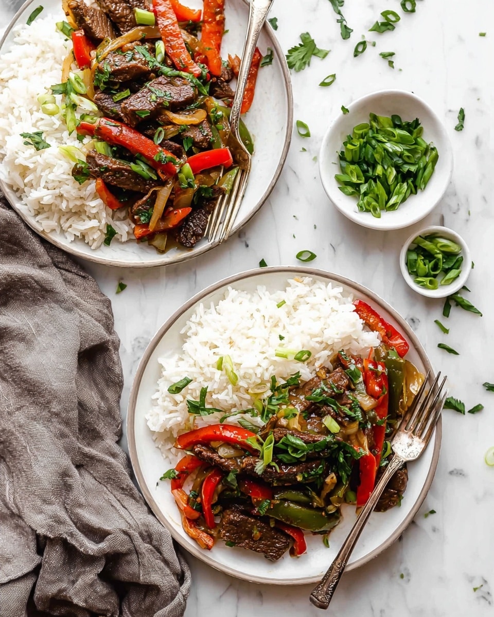 Two white plates filled with white rice and a stir-fry mix of dark brown cooked beef strips, bright red bell pepper slices, and light golden cooked onions, topped with chopped green onions and fresh green herbs. Each plate has a silver fork resting on the edge. In the background on the white marbled surface, there are two small white bowls, one filled with chopped green onions and the other with chopped fresh herbs. A soft gray cloth is casually placed near the plates. The scene is bright and clean with scattered herbs on the surface photo taken with an iphone --ar 4:5 --v 7