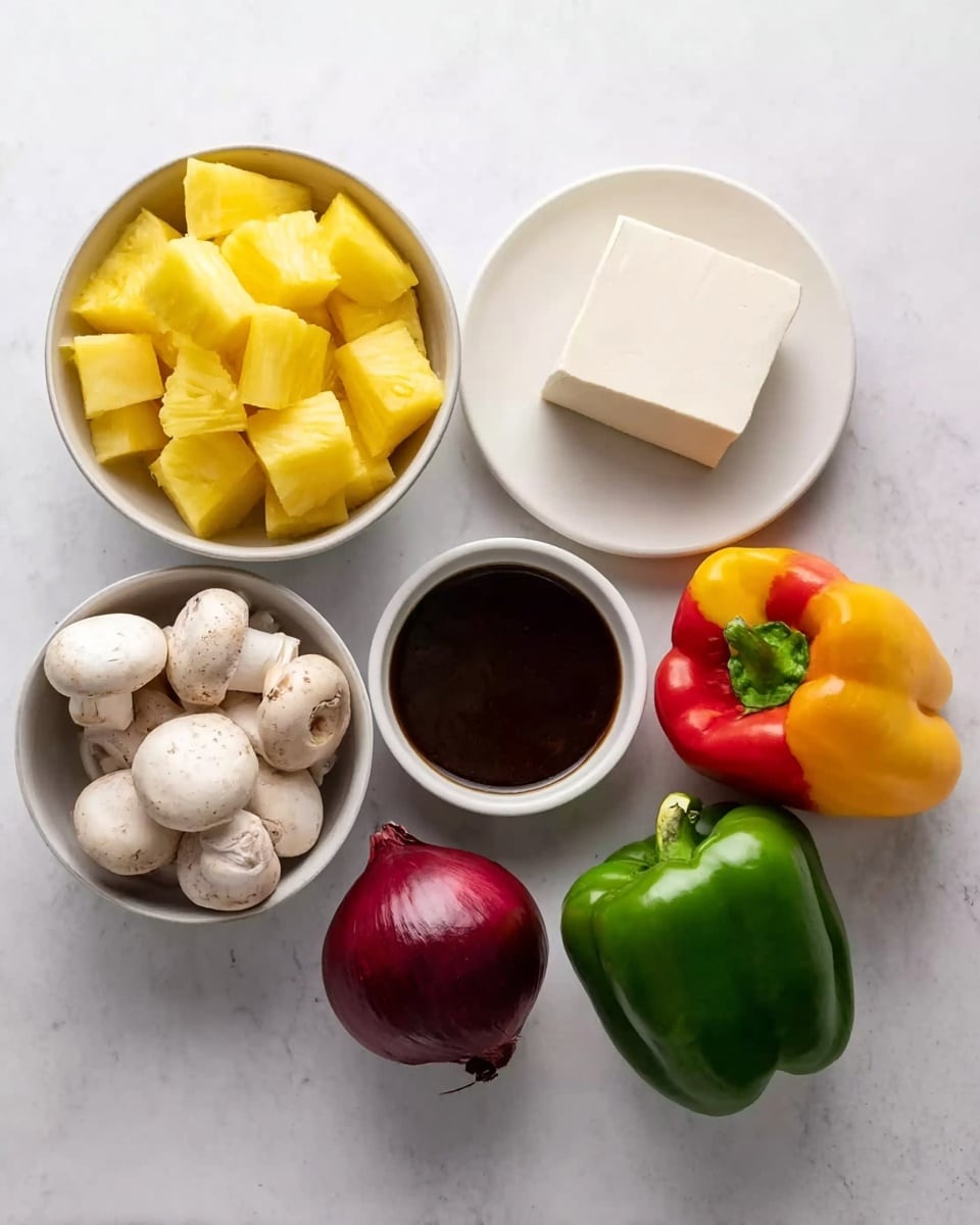 A white marbled surface holds six items: starting at the top left, a white bowl filled with bright yellow pineapple chunks; next to it, a white plate with a rectangular block of light beige tofu; below the pineapple bowl, another white bowl filled with whole white mushrooms; centered beneath the tofu, a small white bowl filled with thick dark brown sauce; to the left of the sauce bowl, a small round red onion with deep purple-red skin; and scattered around the sauce bowl are three whole bell peppers in green, red, and yellow, each showing smooth, shiny skin. Photo taken with an iphone --ar 4:5 --v 7