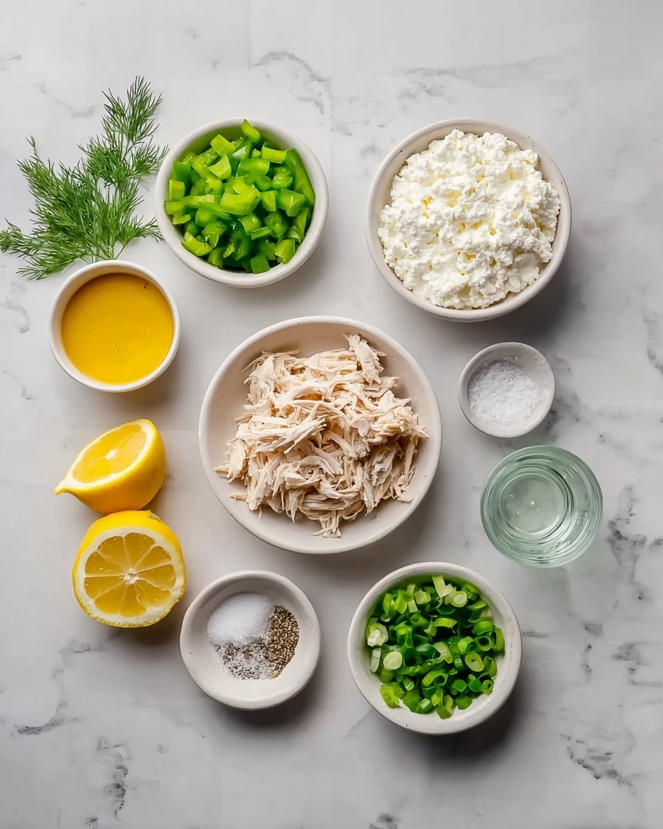 The image shows a top view of several small white bowls arranged on a white marbled surface, each holding different ingredients. In the center, a white bowl holds shredded light brown chicken. Above it, a white bowl is filled with soft white cottage cheese. To the left, there is a white bowl with chopped green bell peppers and another small bowl containing yellow mustard sauce. Next to these, two lemon halves with bright yellow flesh rest on the surface. To the right of the shredded chicken, a white bowl holds chopped green onions, and a smaller white bowl contains a mix of white salt and black pepper. Above the pepper and salt, there is a tiny glass with clear liquid. Finally, a small bunch of fresh green dill is placed near the salt bowl. The neat arrangement of the ingredients creates a clean and fresh look. photo taken with an iphone --ar 4:5 --v 7