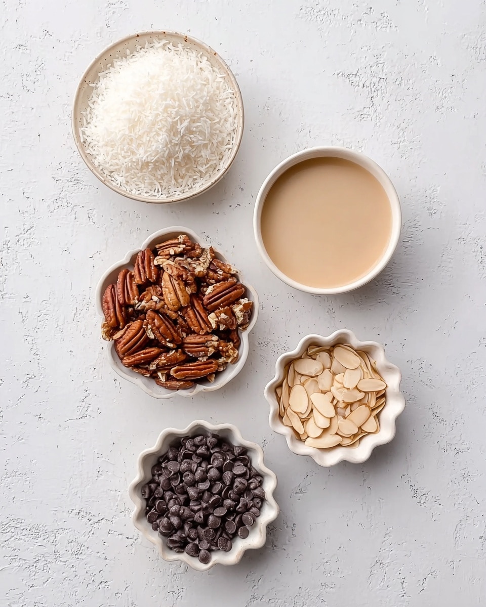 The image shows five small white bowls placed on a white marbled surface. One bowl contains a fluffy pile of shredded white coconut on the top left. Next to it on the right is a small bowl filled with a smooth, light tan liquid. Below these, on the bottom left, is a scalloped white bowl filled with chopped pecans in various shades of brown. To the right of the pecans is another scalloped white bowl containing sliced almonds with a light tan color. The bottom right bowl is filled with dark chocolate chips that are shiny and round. The setup is neat with each bowl clearly showing its contents, all on a soft, clean white marbled background. photo taken with an iphone --ar 4:5 --v 7